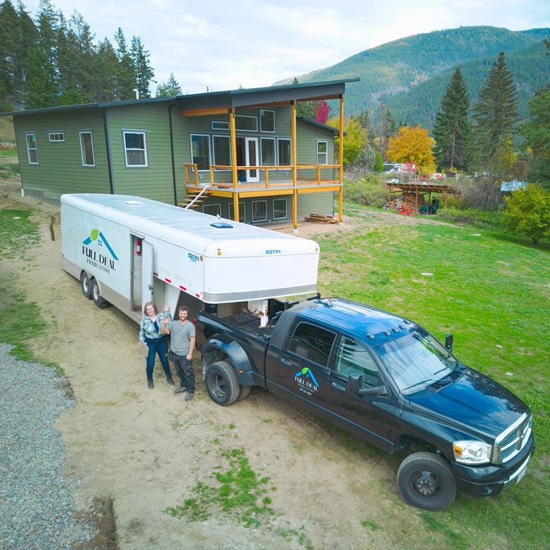 Professional-Insulation-Services-Creston-BC-Canada Heather and Tyler Banman owners of Full Deal Insulation standing with truck and trailer.